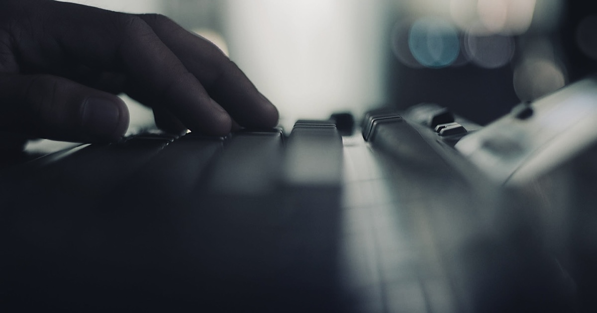 パソコンのキーボードをタイピングする指先